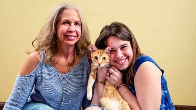 Micah Thompson and her cat, Ron, and mother Stephanie
