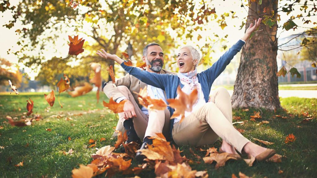 Couple in park enjoying autumn leaves (Getty)