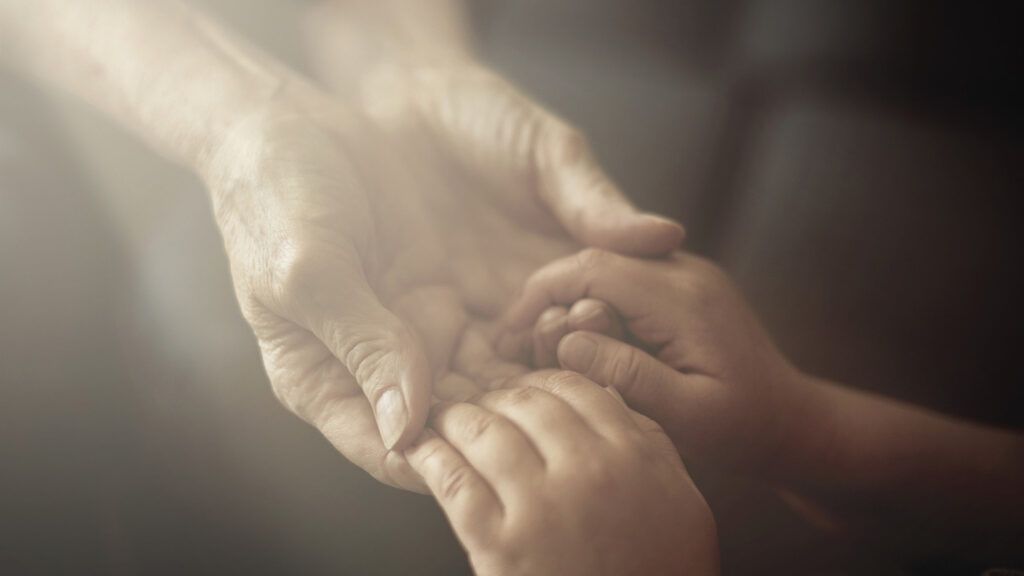 grandson_holding_grandmother_hands_close_up_view_getty_images