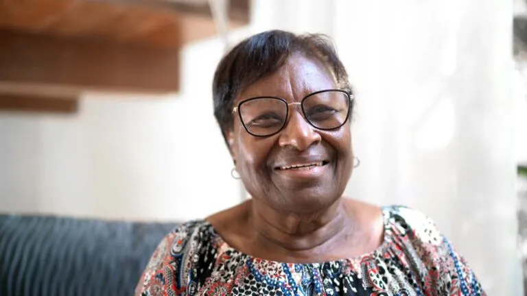 A senior woman smiling; Getty Images