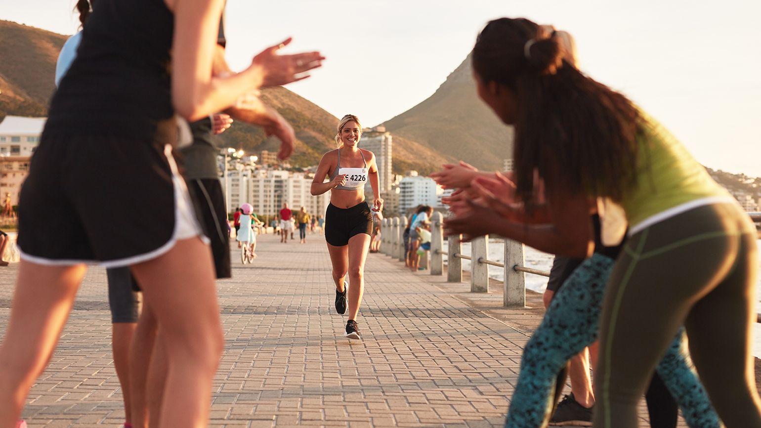 People cheer on marathon runners