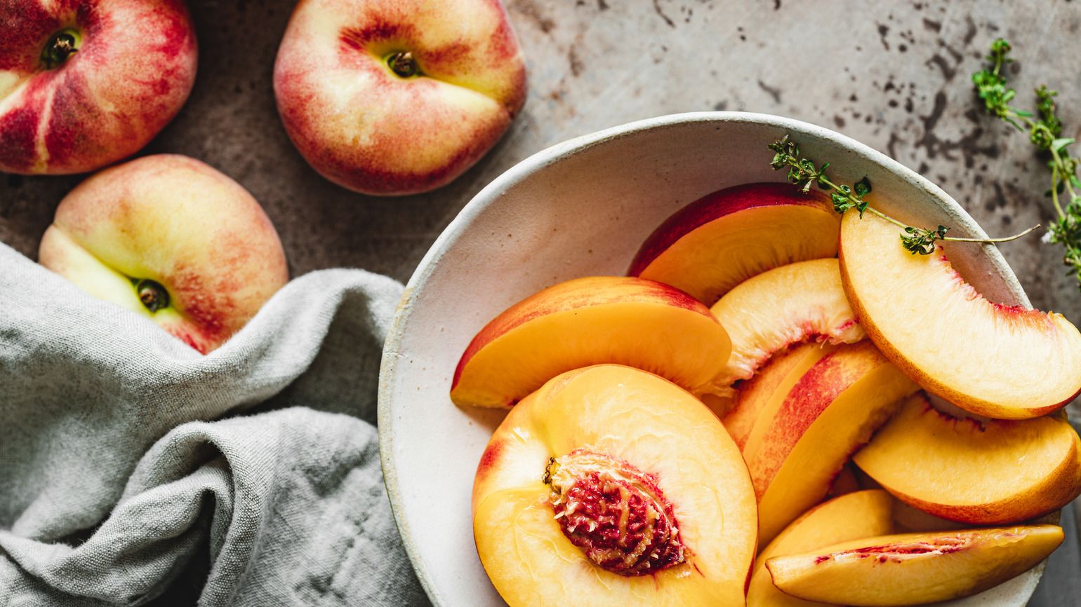 Slices of ripe peaches in a bowl (Getty Images)