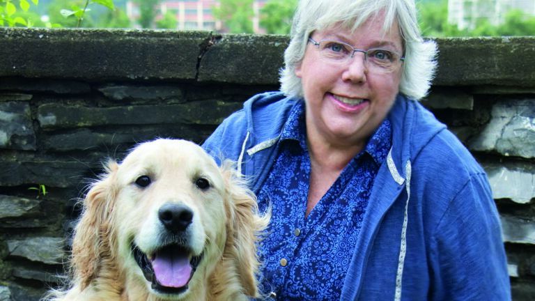 Peggy Frezon and her two golden retrievers, Petey and Earnest
