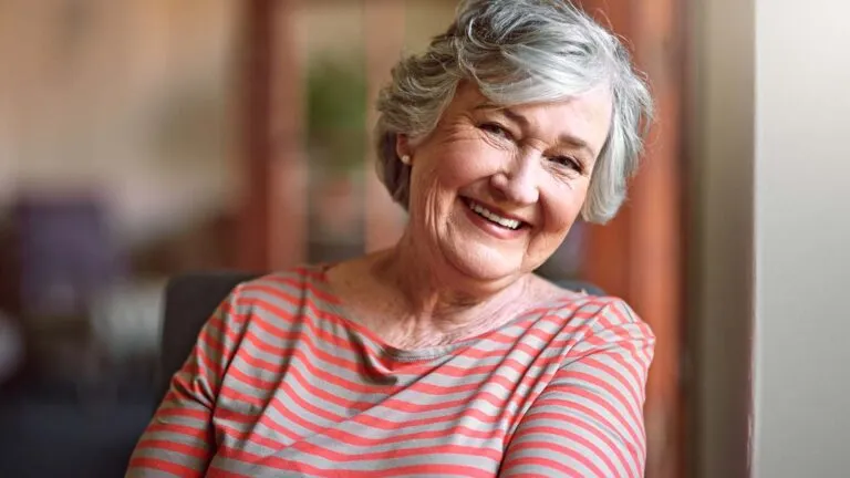 Woman smiling at camera; Getty Images