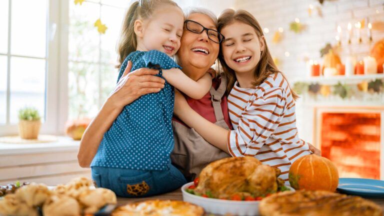 Grandmother and her grandchildren during Thanksgiving dinner; Getty Images