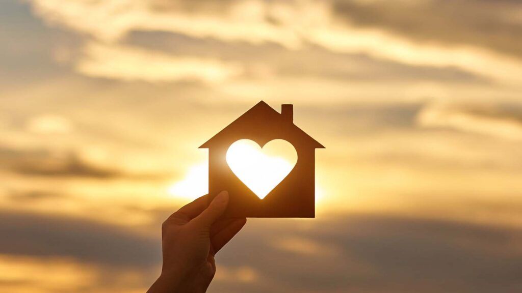 A cut out of a house with a heart inside; Getty Images