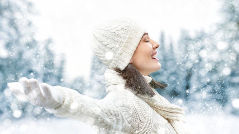 A joyful woman exults on a winter's day