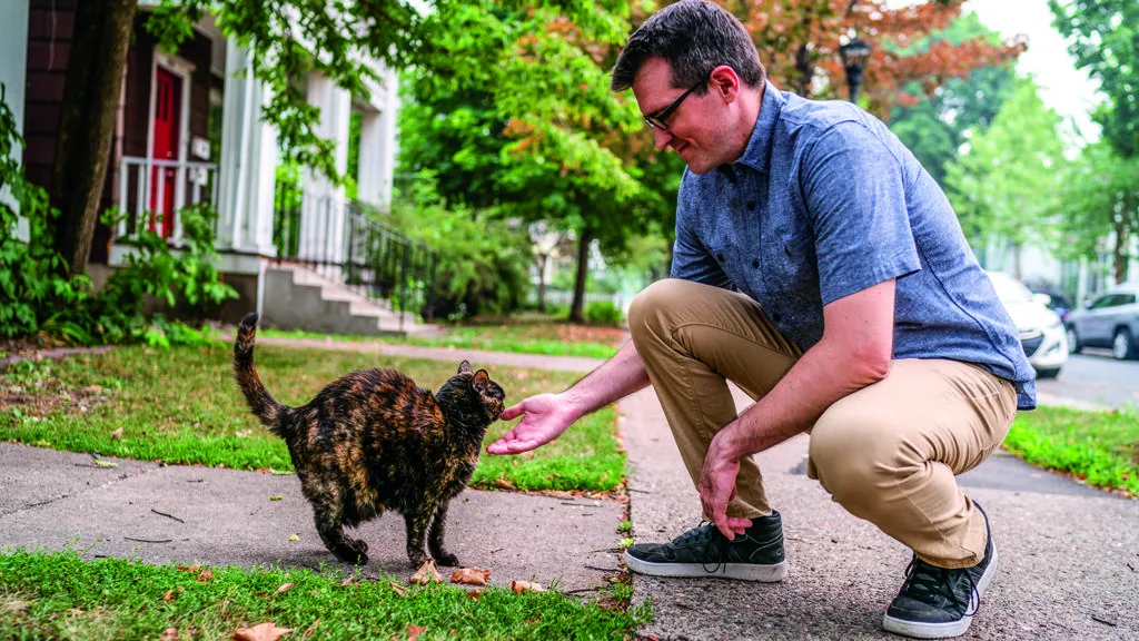 John greeting a cat named Fish