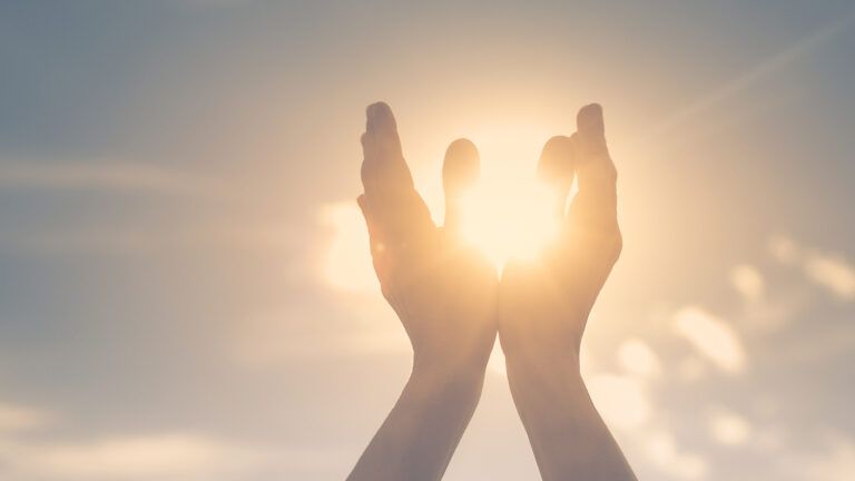 Hands held up to sunlight are God's hands