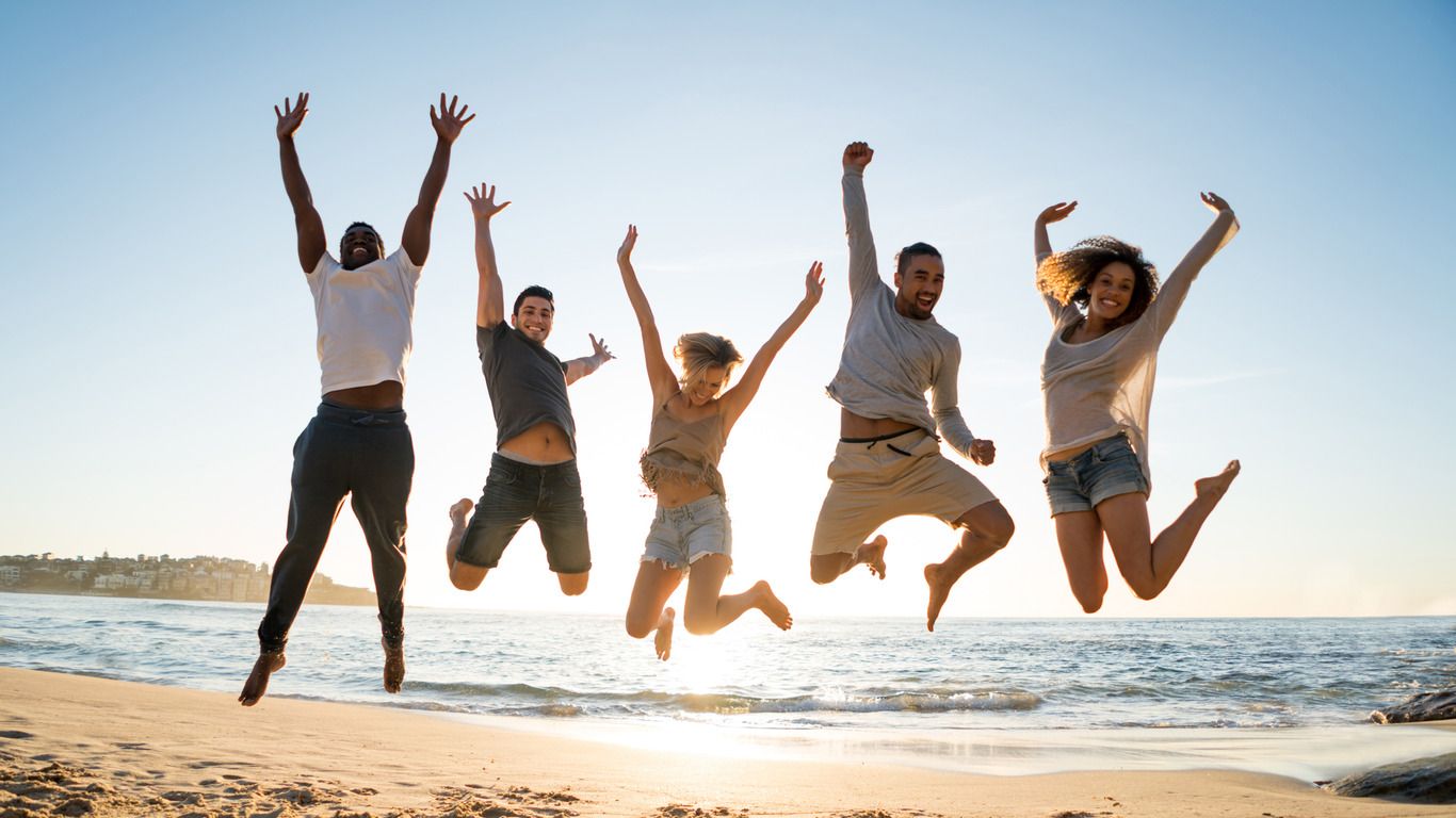 A group of friends jumping for joy about God's hands