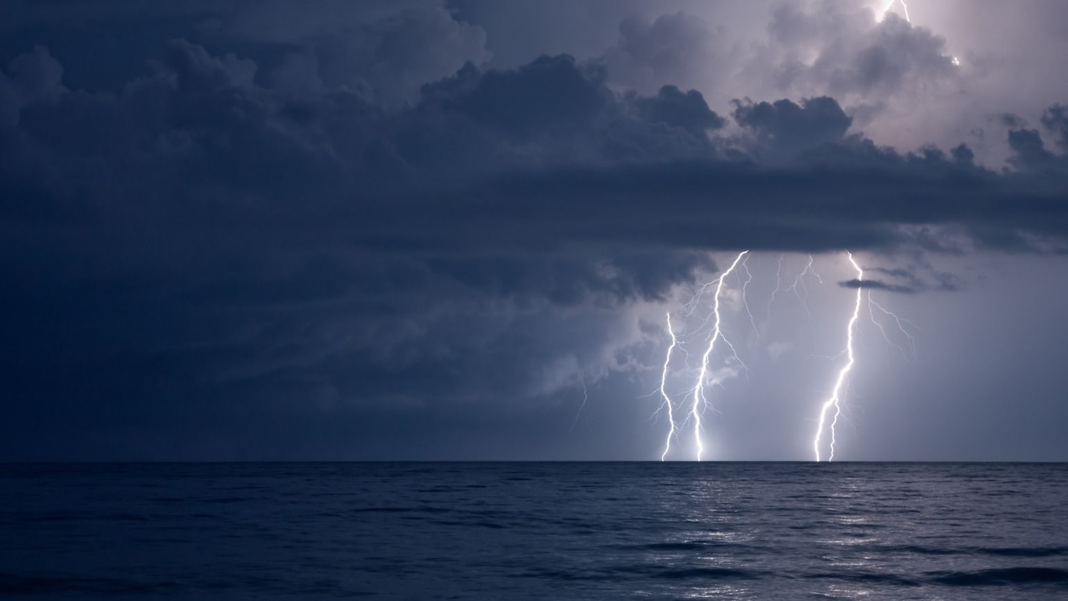 Lightning on an ocean at night is an example of God's hands
