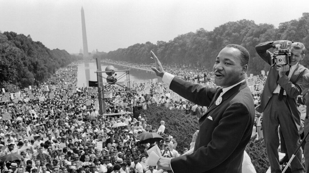 Martin Luther King waves to supporters August 28, 1963, on the Mall in Washington, DC.