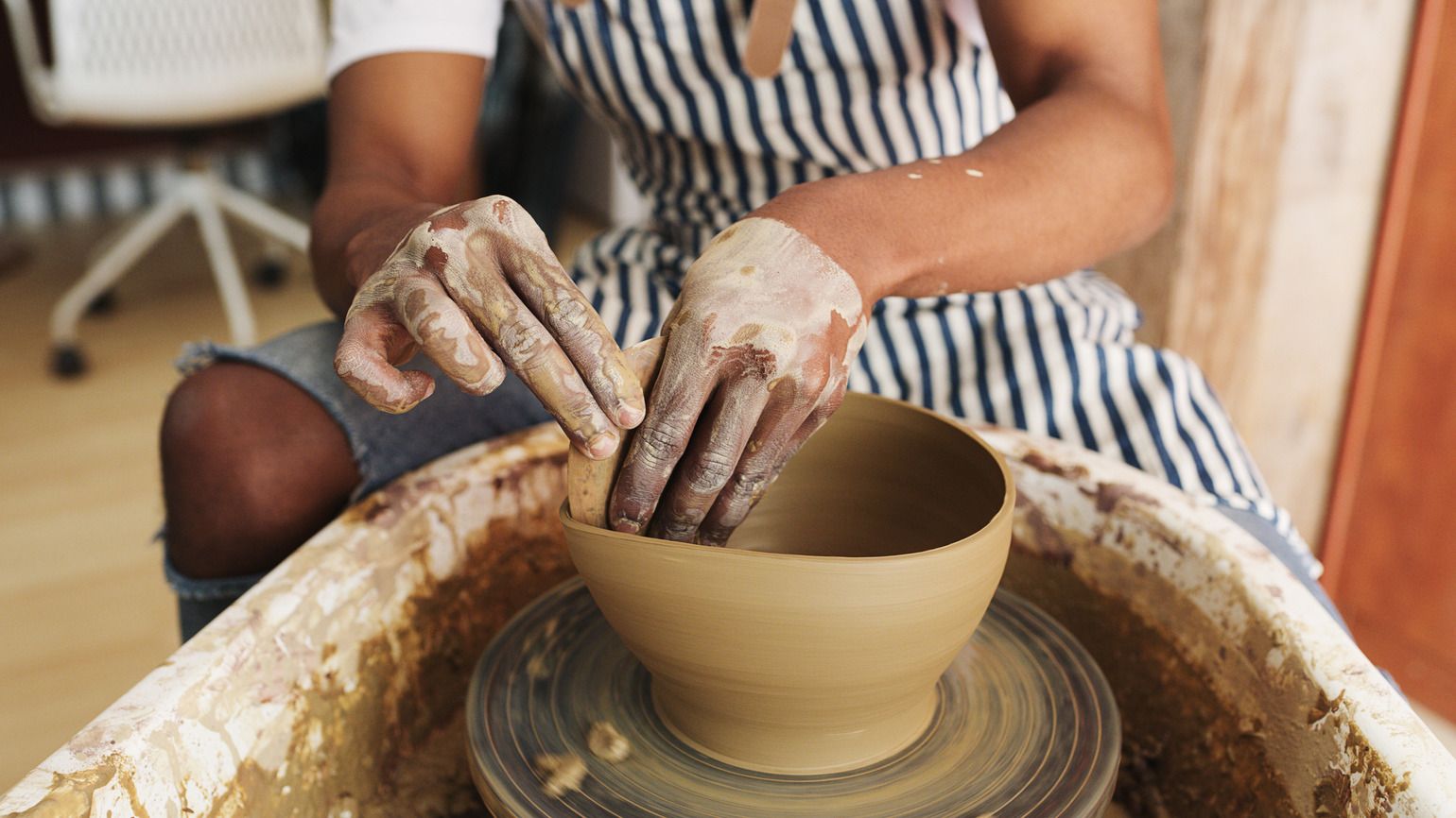 Hands creating with pottery of God's hands