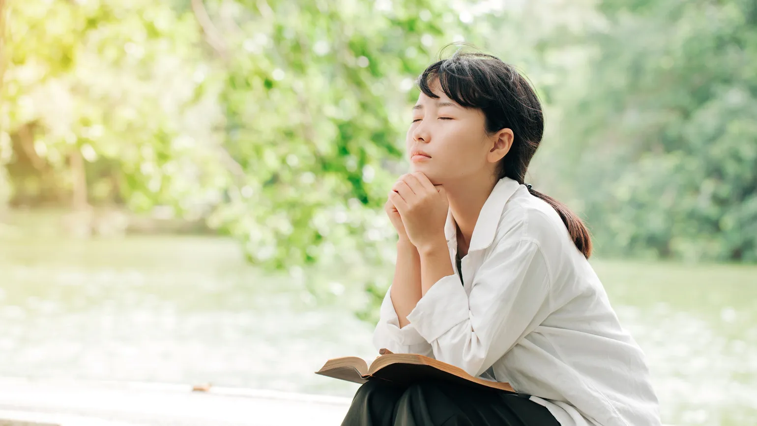 A woman praying about God's hands