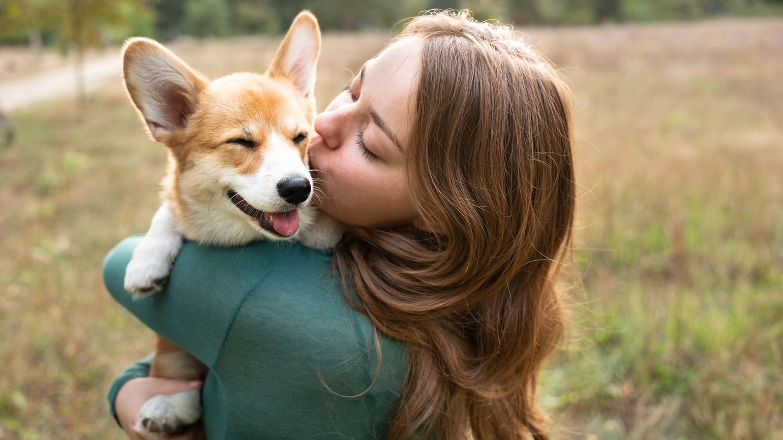 A woman with her happy corgi puppy thinking about God's hands