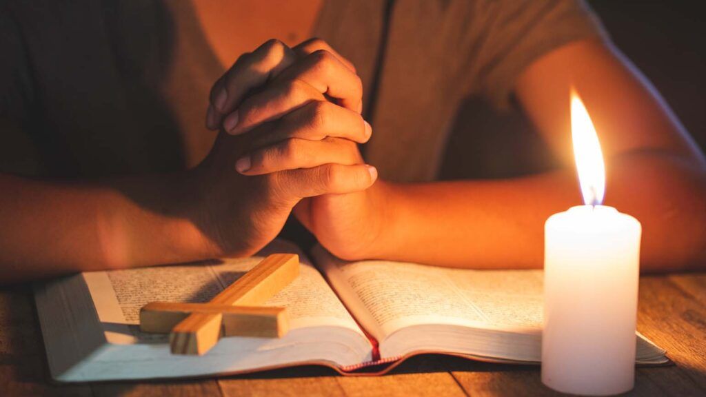 Prayer by candlelight; Getty Images