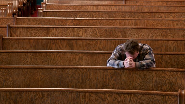 A man prays alone in church