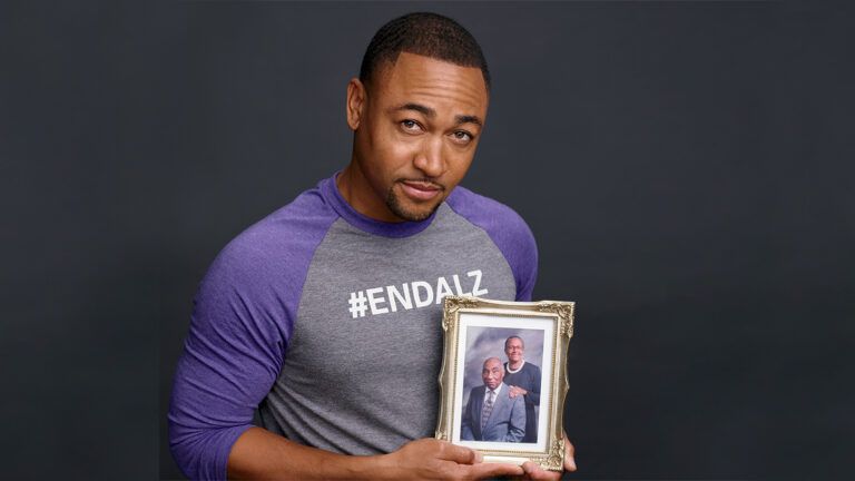 Percy Daggs III with a photo of his grandparents; photo courtesy Alzheimer's Association