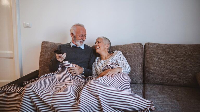 Senior couple watching TV at home