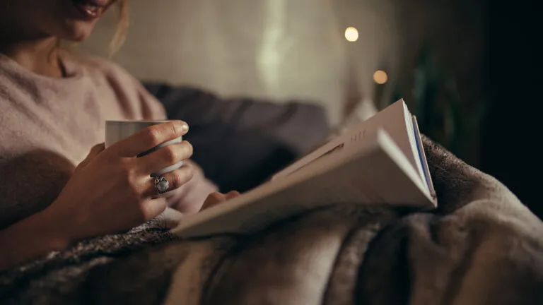 Woman reading a book in the evening