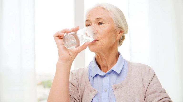 Senior woman drinking water