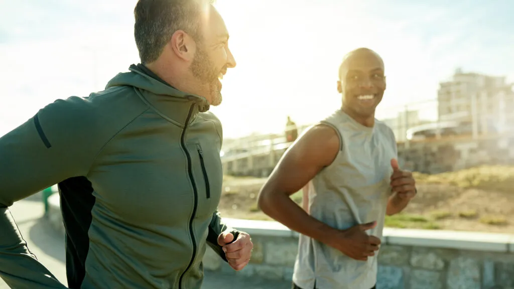 Two men exercising together and talking about Bible verses for walking and running