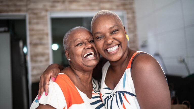Adult woman and senior woman smiling