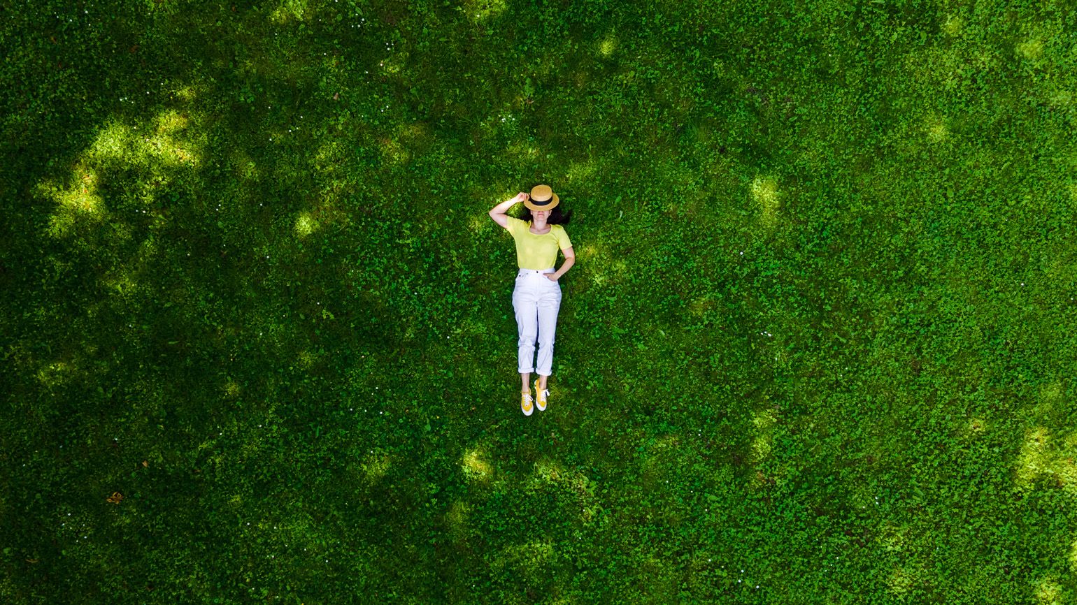 Woman lying down on grass; Getty Images