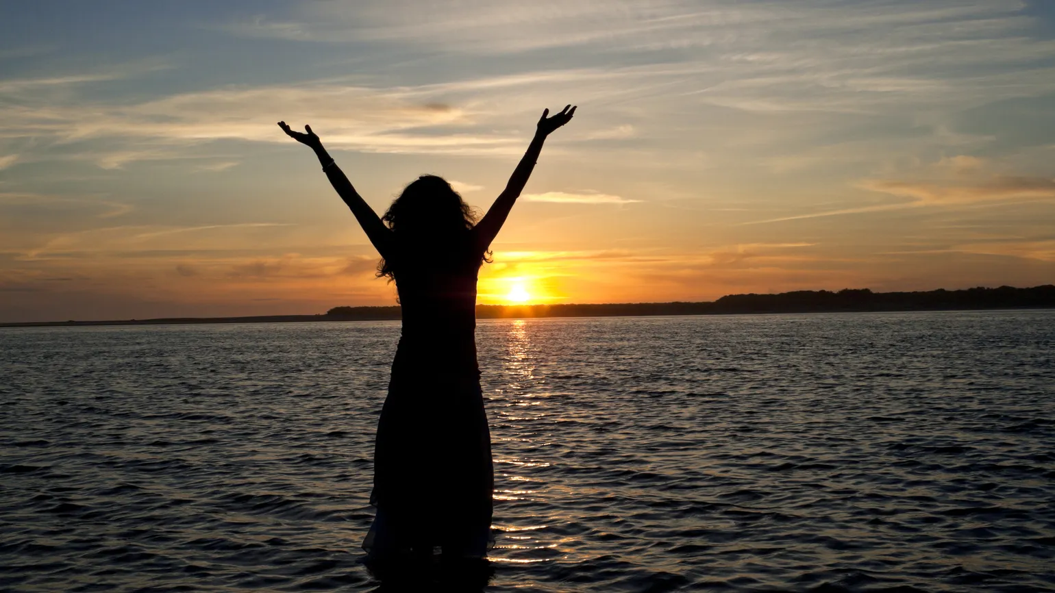 A silhouette of a woman standing in water tells us what does heaven look like