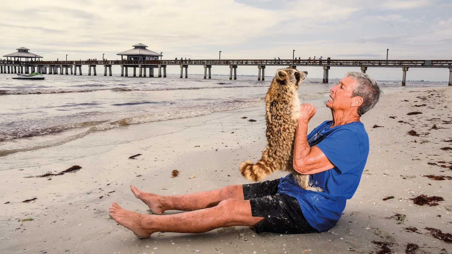 Dot Lee and her raccoon on the beach in inspiring stories of animals helping humans