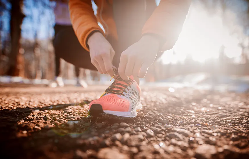 A female runner tying her shoe