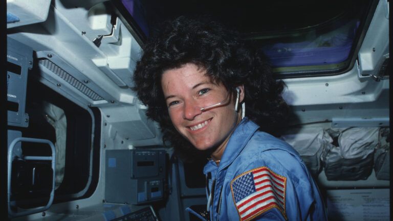 Sally Ride poses on flight deck with inspirational quotes from NASA Astronauts