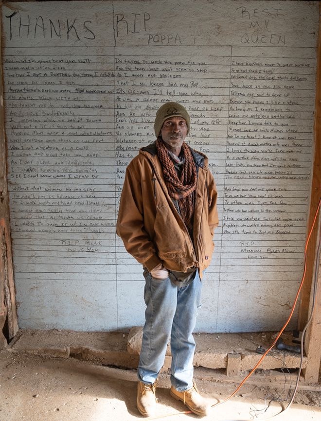 Rodney stands before his memorial wall; photo by James Kegley