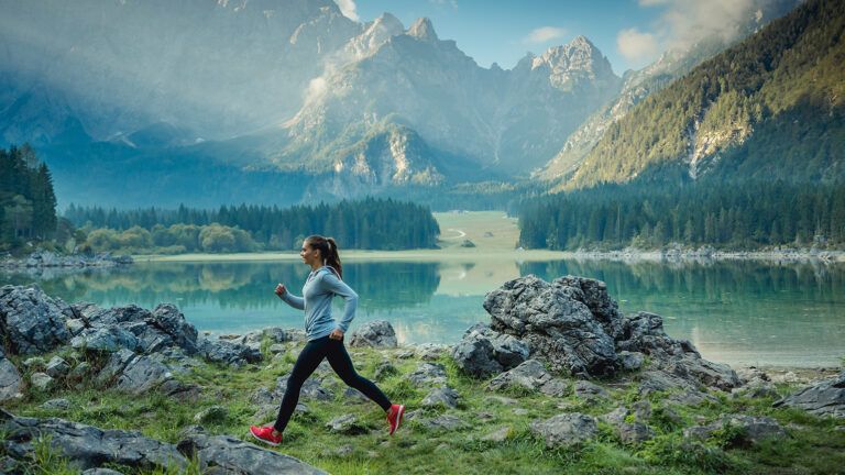 A woman runs long-distance in the mountains