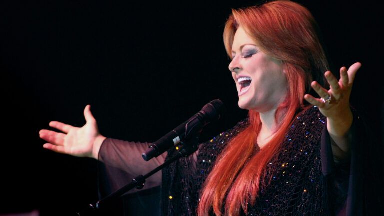Country music artists Wynonna Judd performing onstage in her story of faith