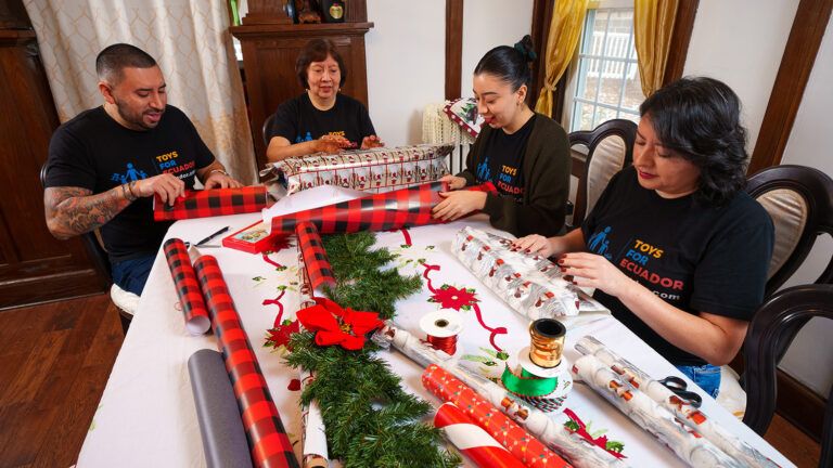Byron wraps gifts with his mother, Aida and sisters Lorena and Tiffany: Photo by Todd Plitt