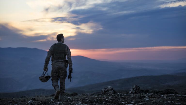 A soldier walking at sunset telling a soldier story