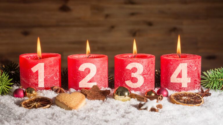 Four red lit candles symbolizing the four Advent themes