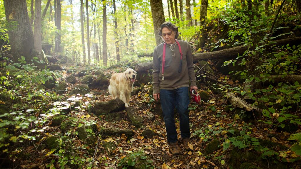 Edward and his dog Gracie walking through the woods to celebrate lent without church