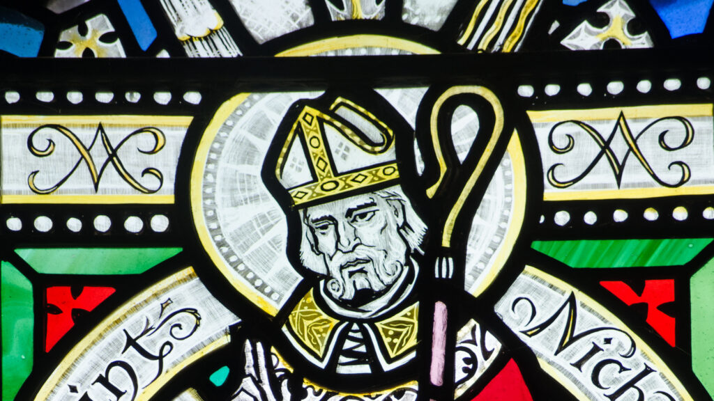 A Victorian stained glass window depicting Saint Nicholas in the history of Santa Claus