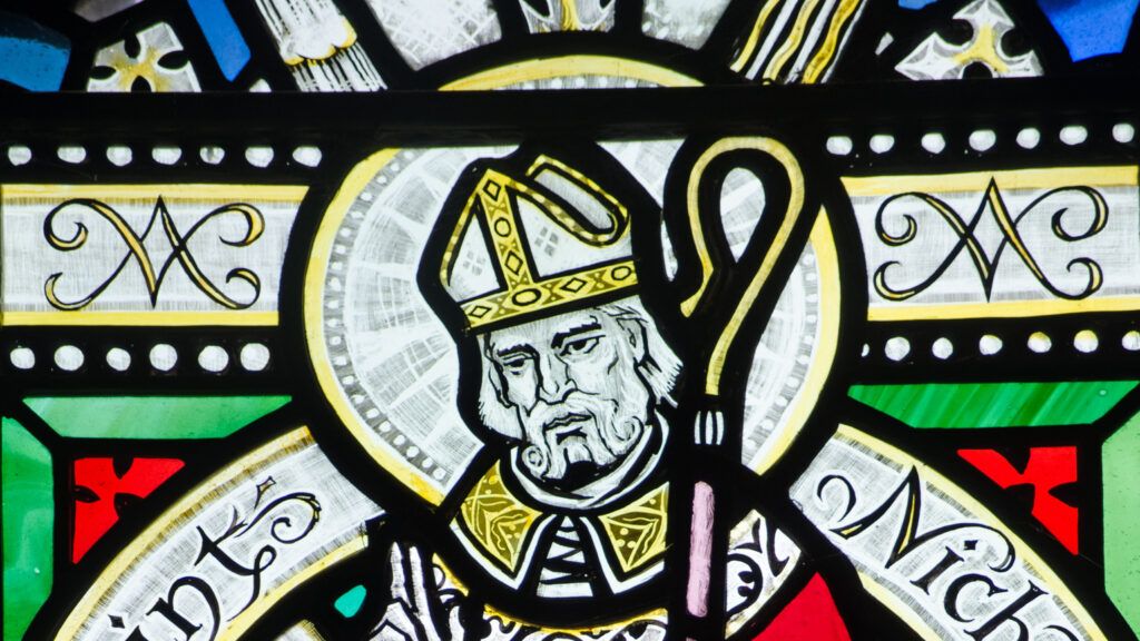 A Victorian stained glass window depicting Saint Nicholas in the history of Santa Claus