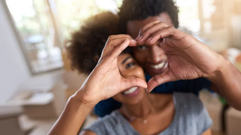 A couple making a heart with their hands as a marriage habit