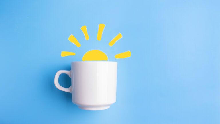 Coffee cup on a blue background with a sun showing micro habits for monday
