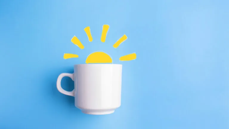 Coffee cup on a blue background with a sun showing micro habits for monday