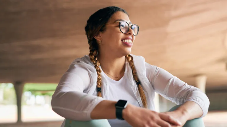 Smiling woman in workout clothes does her exercise bible habits