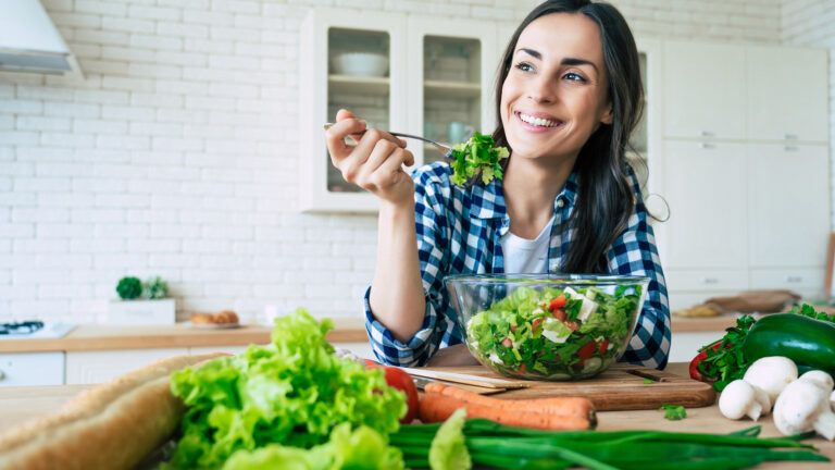 Woman makes a healthy bible habit and eats a salad