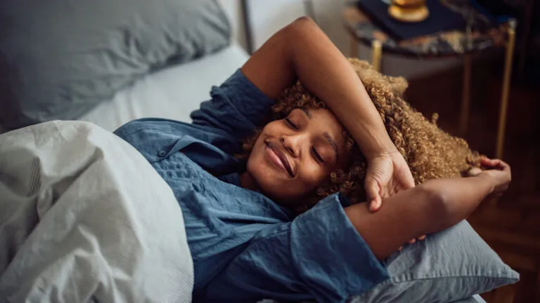 Woman resting in bed for her bible habits