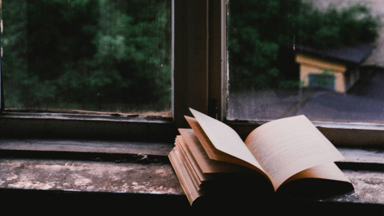 A devotional book near a glass window. Credit: Unsplash