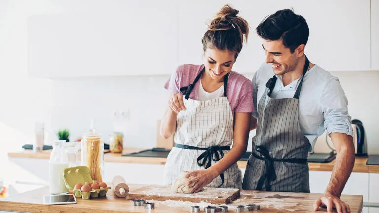 Happy newlyweds cook together for their marriage habits