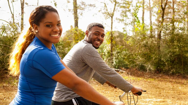 A young couple rides bikes together